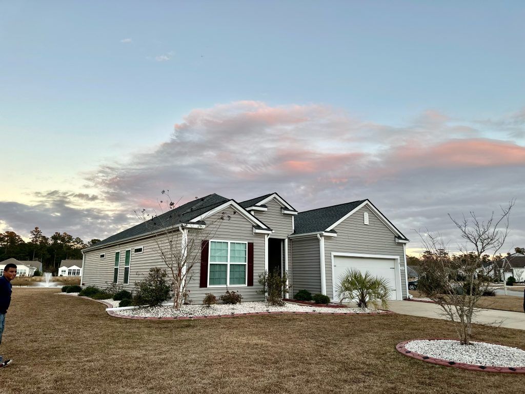 Single-story home with a new shingle roof photographed at dusk in Myrtle Beach, SC