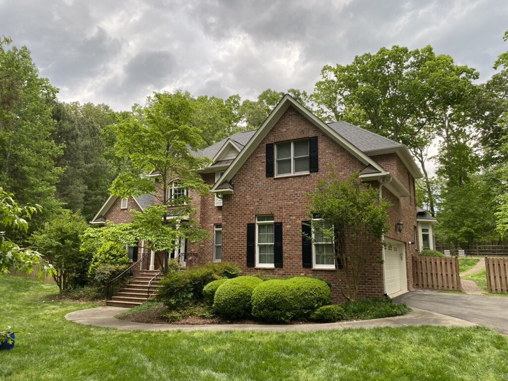 b7234445-aa49-4af5-929d-3e415d2610ac Close-up view of a newly installed dark gray shingle roof in Raleigh, NC