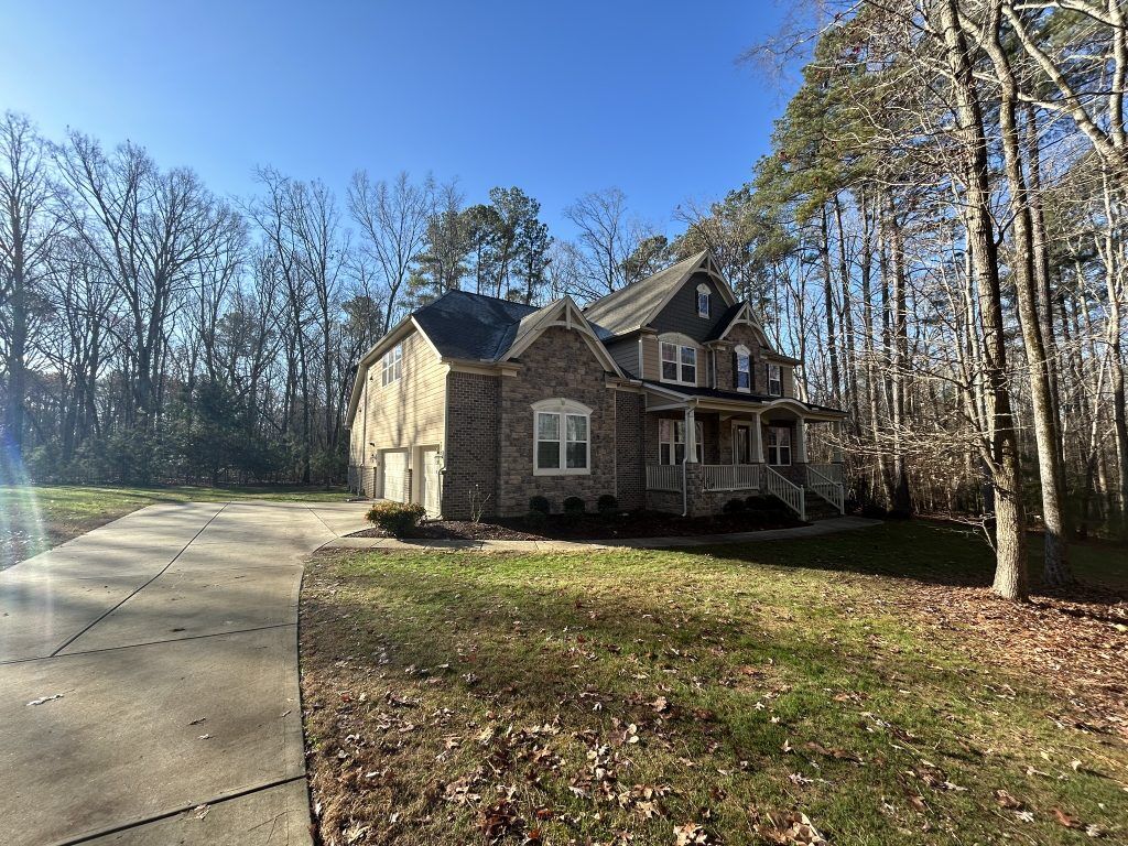 item_928e4b58-9cd3-479f-a524-5ce8522c046e Two-story home with a covered porch and new dark shingle roof in Raleigh, NC