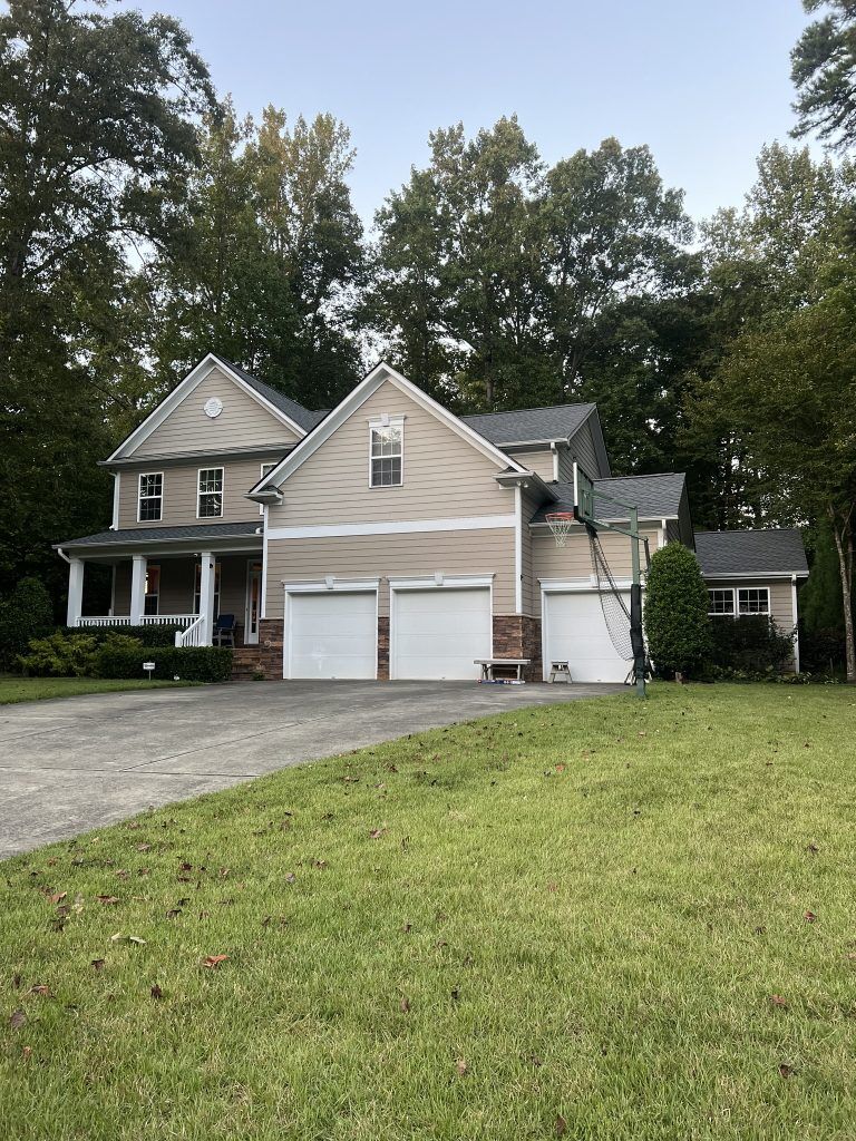 item_c1148471-1be4-4dac-a7fc-0702a613398a Single-story home with a new architectural shingle roof and mature trees in Raleigh, NC