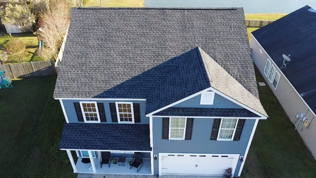 Single-story brick home with a covered porch and new shingle roof in Charleston, SC
